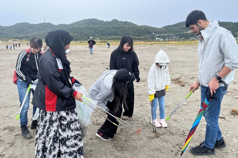 Participants collecting trash at Teradomari Chuo Beach